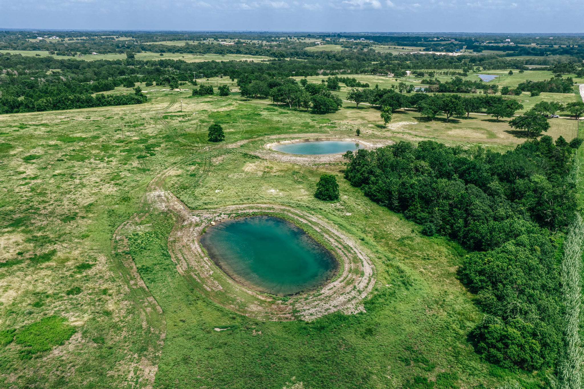 Aerial overview of Lot 1 at The Clearing — pond and pasture